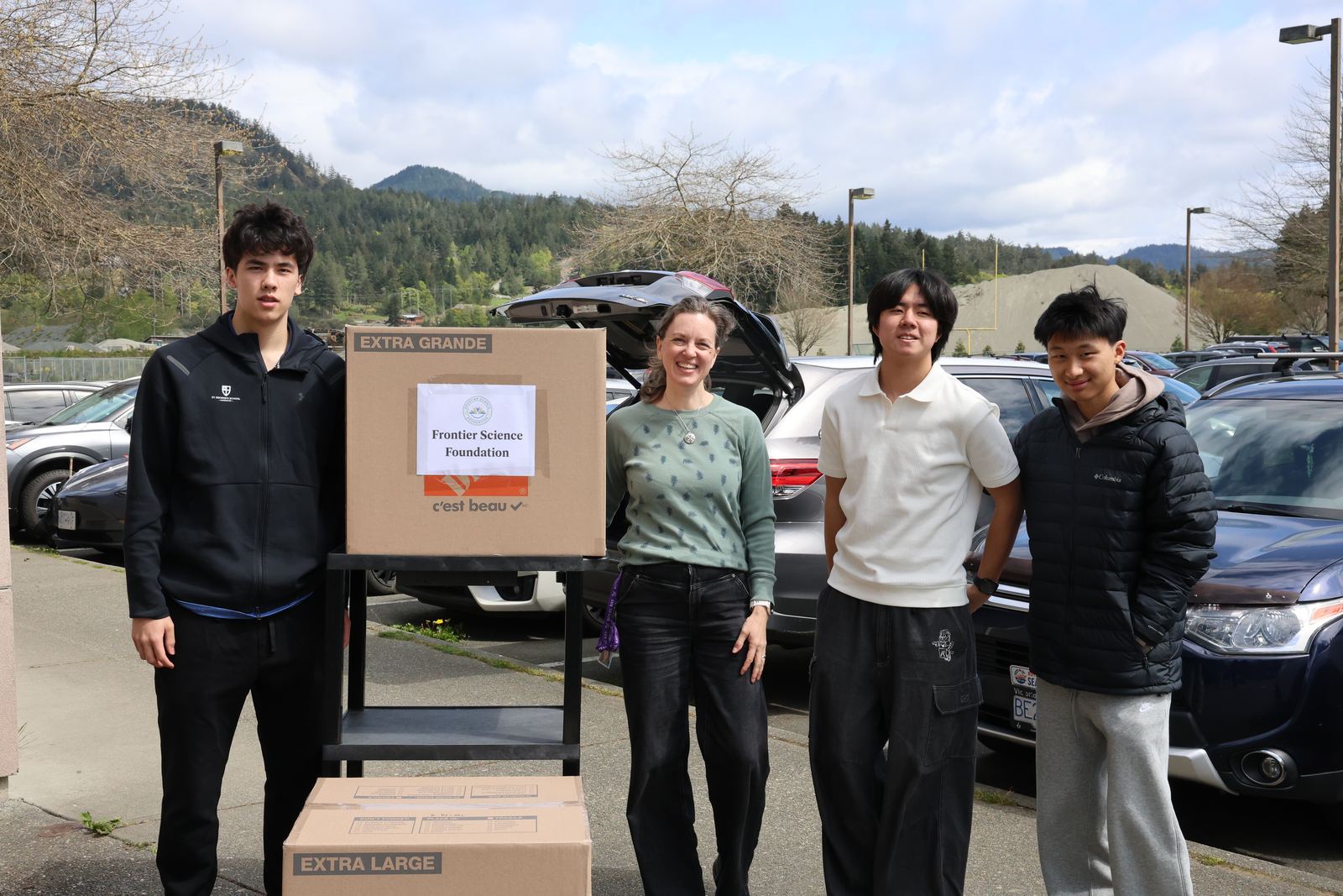 Volunteers with a cart of Frontier Science Foundation donation boxes on Vancouver Island