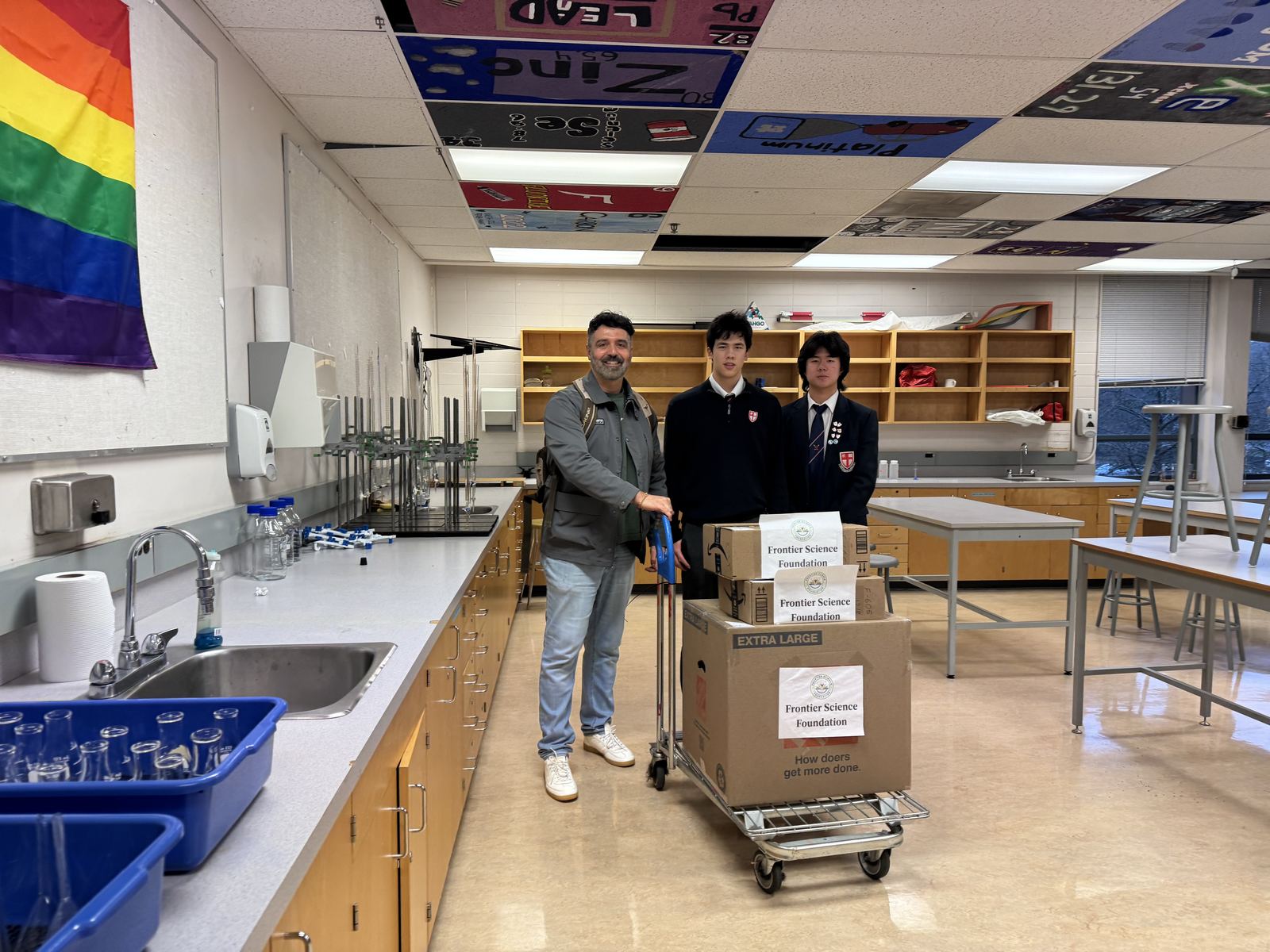Students delivering a cart of equipment into the L.A. Matheson science lab
