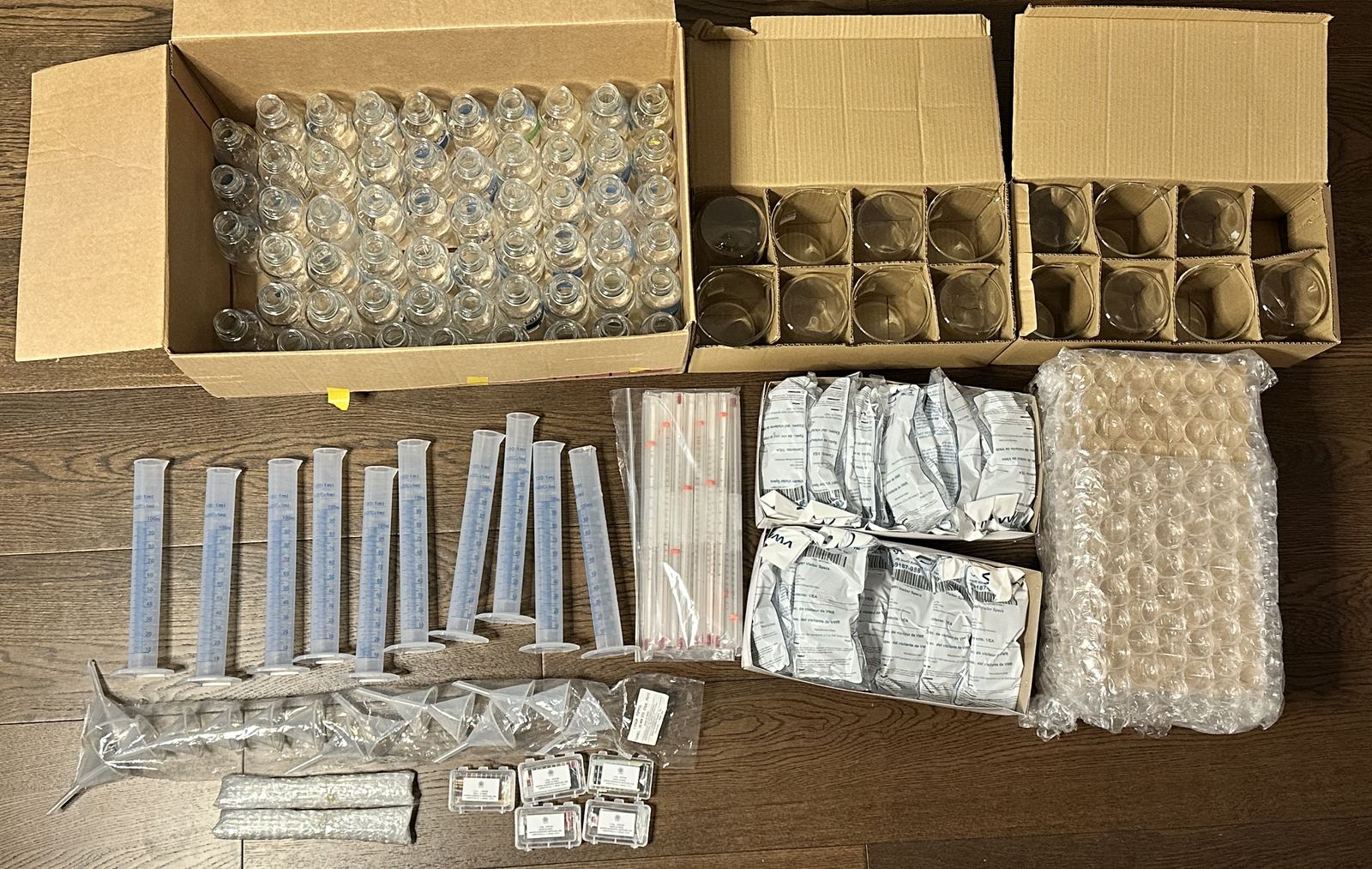 Boxes of beakers, droppers, and lab supplies packed for North Surrey Secondary